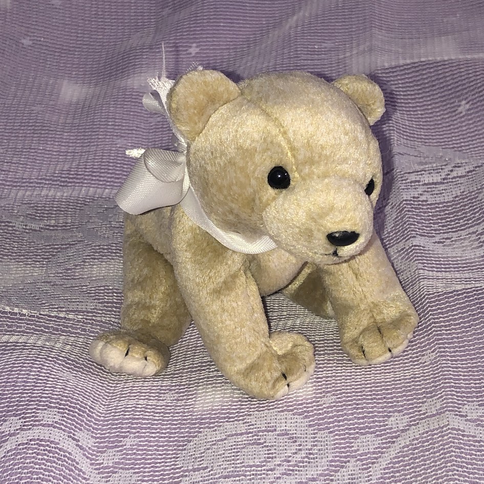 Small bear plush with bow