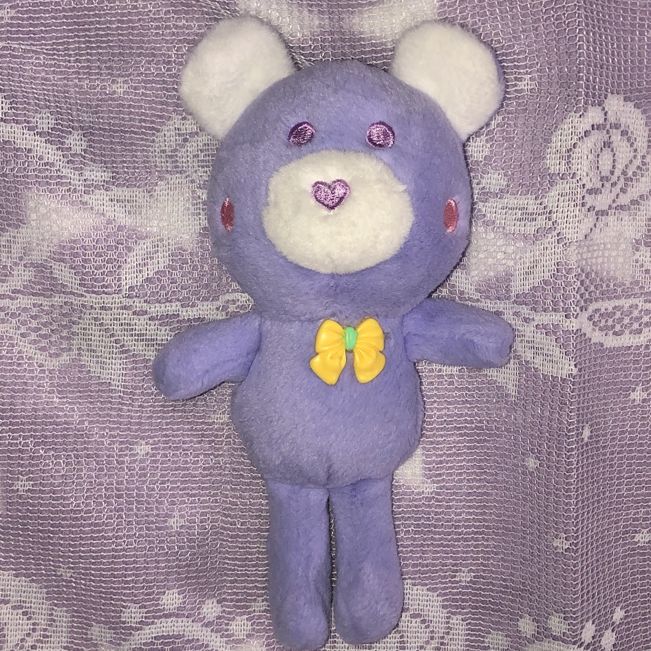 Periwinkle bear with pink eyes and yellow bow