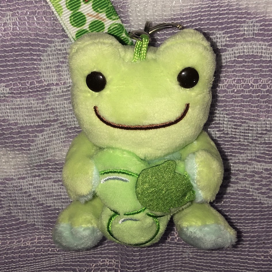 Pickles the frog holds clover
